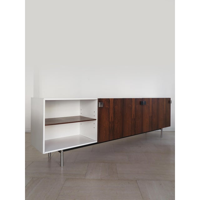 Large sideboard with 4 doors and 1 open compartment, featuring white Formica and dark wood veneer, metal handles and legs....