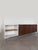 Large sideboard with 4 doors and 1 open compartment, featuring white Formica and dark wood veneer, metal handles and legs....