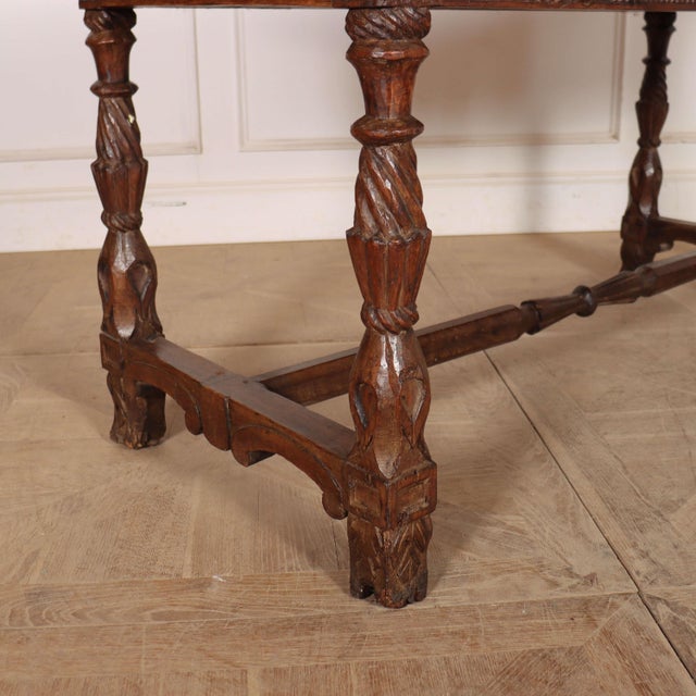 Early 19th century Portuguese carved chestnut two drawer writing table/ desk. Carvings on all sides with a two plank...