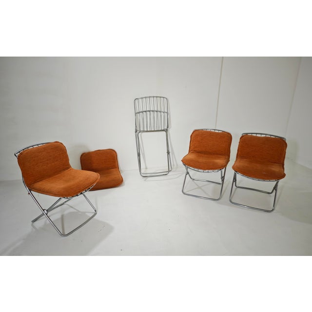 Iconic set of four vintage folding chairs in chromed steel rod from the 1970s, designed by renowned Italian designer...
