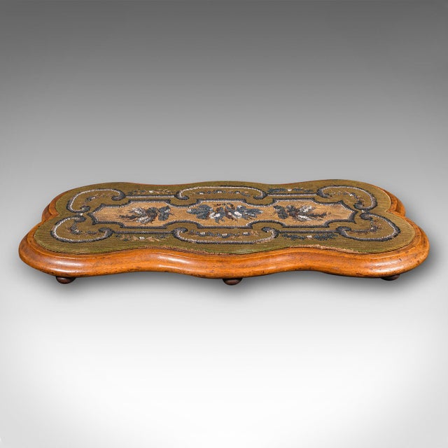 This is a charming antique tea fancies stand. An English, walnut and beadwork raised cake platter, dating to the Victorian...