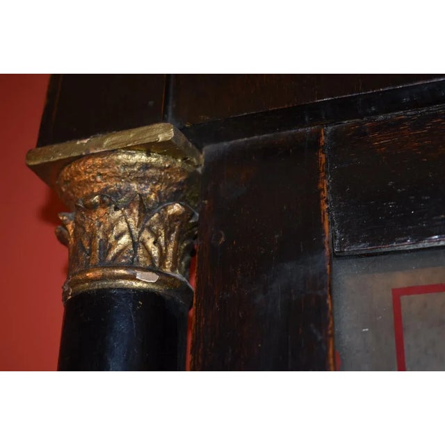 Late continental neoclassical mirror with an eglomise' painted panel above. Flanked by Corinthian capped columns and dark...