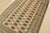 A tribal Bokhara rug hand-knotted with fine wool on a cotton foundation. This rug features rows of repeating medallions...