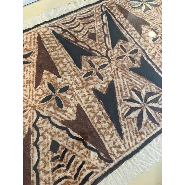 Immerse your space in the rich textures of Polynesian design with this framed tapa cloth artwork. Evoking a sense of the...