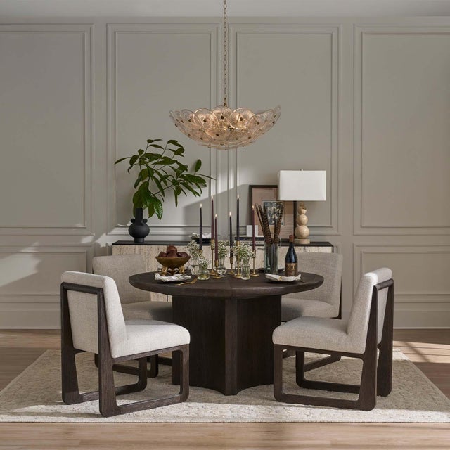 The Holly chandelier is captivating, featuring overlapping glass discs with intricate linear details reminiscent of...
