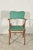 Chair with armrests, solid wood frame and seat with back in green leatherette pintiricchiata black edging italy 1960...