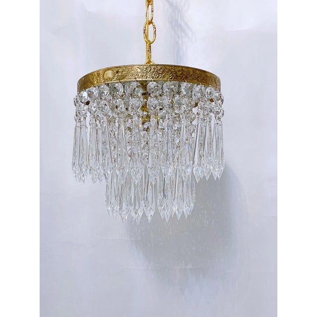 This is an Italian brass rim chandelier dressed with octagon bead and Plug cut crystals. It has 1 Edison base socket....