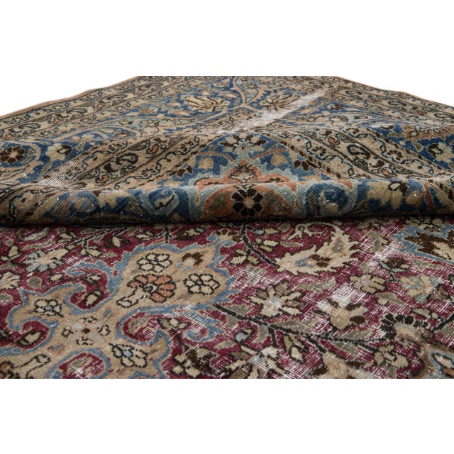 Beautiful hand-knotted antique Mashad wool rug. This rug has a blue and red field. This rug features a traditional...