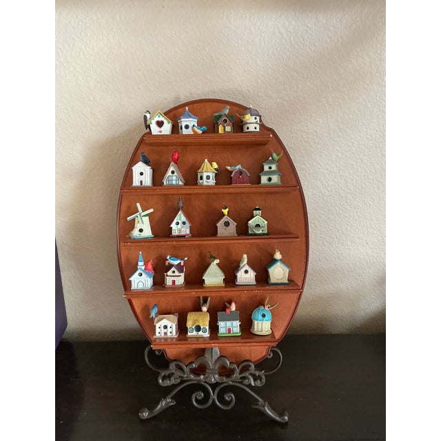 Celebrate the whimsy of avian architecture with this vintage oval wall-mounted display shelf, housing 20 miniature...