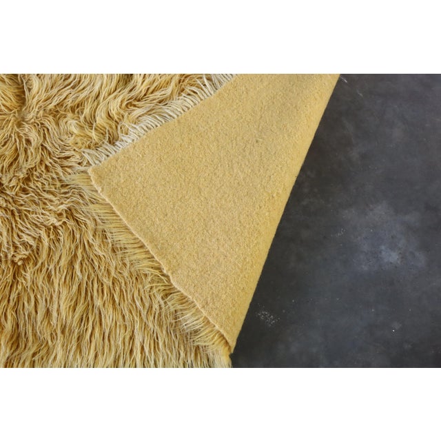 Very groovy vintage wool orange Greek/Grecian Flokati shag rug. Its pile measures 3 inches. It is in good vintage...