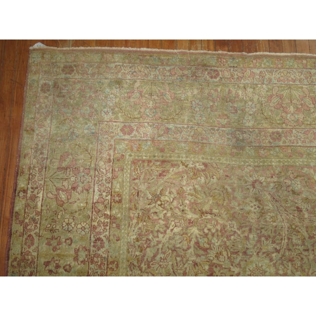 A highly decorative floral Persian rug with a formal presence. Caramel ground with hints of soft blues, raspberries,...