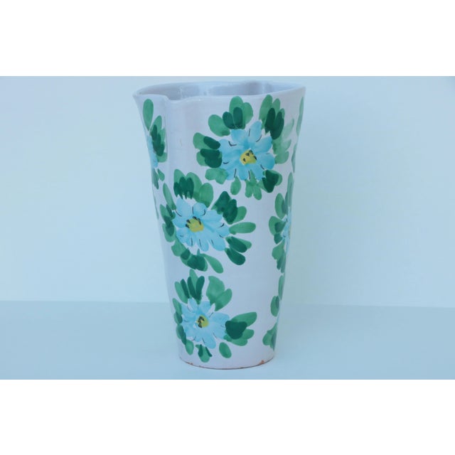 Mid-century Italian faience vase with a hand painted blue floral design. The blue flowers wrap around both sides of this...