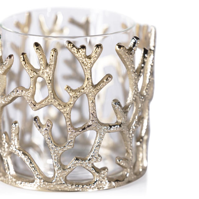 A stunning accent inspired by the beauty of the ocean. This brass hurricane features a textured coral-like frame with an...