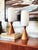 A pair of matching mid century table lamps. Each features a wood base and frosted glass shade. Bases are a medium toned...
