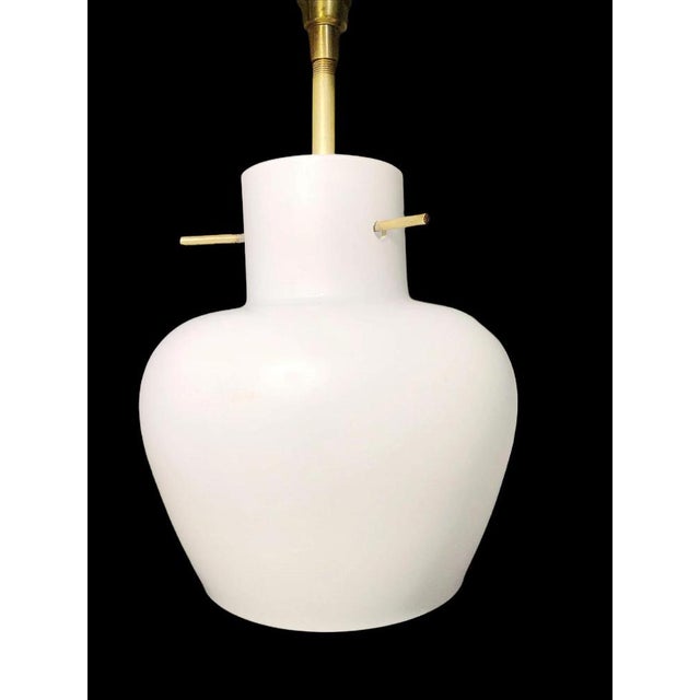 Teak, brass and opaline glass hanging lamp attributed to Stilnovo, 1960s. Simple, geometric design with an innovative...