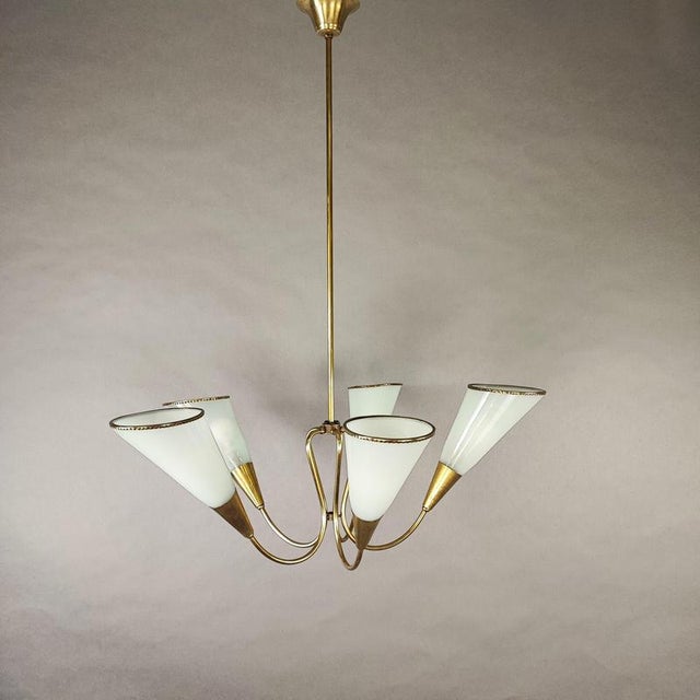 Elegant pendant lamp with a classic Italian design from the 1950s. Five brass arms with cone-shaped lampshades in hand-...