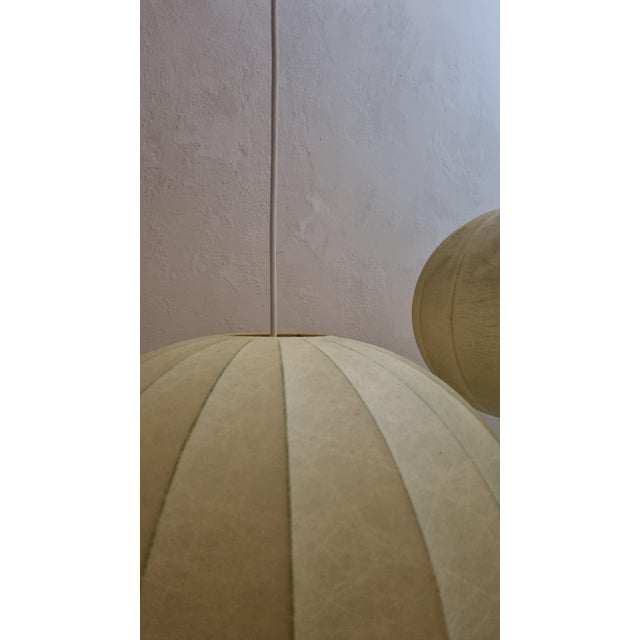 Pair of cocoon pendant lamps, italian manufacture from the 1960s. internal structure in white painted steel, sprayed with...