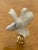 Handmade porcelain figurine of a dove on brass base as lamp finial.