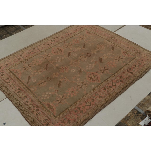 Originating from Turkey circa 1920-1930, this hand-knotted 7x9 wool rug joins the celebrated Oushak selections in Rug &...
