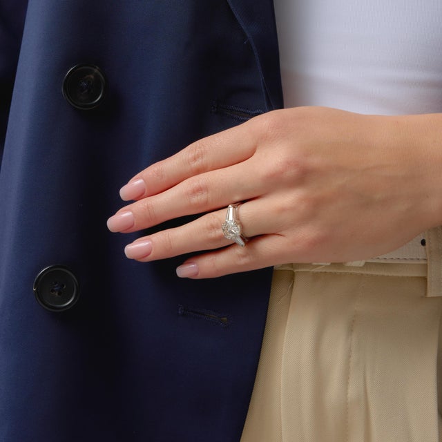 This striking Mid Century engagement ring showcases a remarkable 2.89 carat round brilliant cut diamond, certified by GIA...
