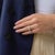 This striking Mid Century engagement ring showcases a remarkable 2.89 carat round brilliant cut diamond, certified by GIA...