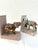 Charming pair of bookends from India featuring cloth covered wood platforms, one with a hard resin figural elephant and...
