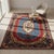This stunning Vintage Persian Kerman rug showcases an elegant floral oval design, surrounded by vibrant red, blue, and...