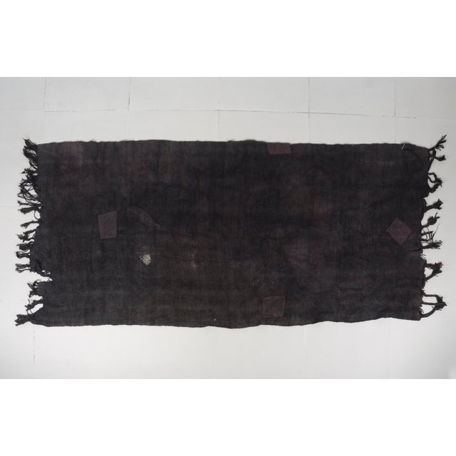 This is a vintage Turkish Oushak rug from the Mid 20th Century. The piece was hand-knotted.