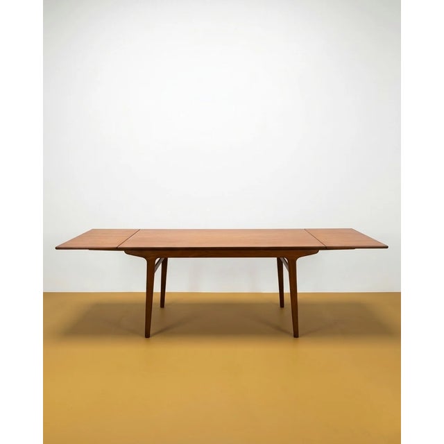 A vintage Danish teak extendable table from the 1960s with an elegant rectangular design and extension system, perfect for...