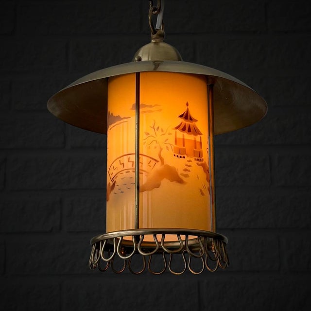 A Swedish 1940s pendant lamp, produced by the manufacturer Edvard Hagman. Crafted from solid brass with a cylindrical...