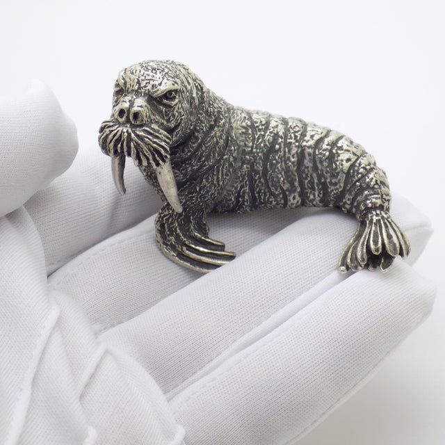 This rare vintage silver animal sculpture depicts a walrus, crafted as a desktop accent, library display piece, or cabinet...