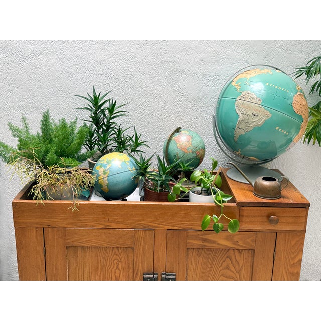 Vintage 8-inch terrestrial globe by The Geo. F. Cram Co. of Indianapolis, Indiana, model No. 80. Constructed with printed...