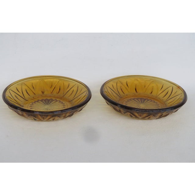 This beautiful Pair of 2 Bowls is made of glass. These lovely bowls have a wonderful Amber color with a central starburst...
