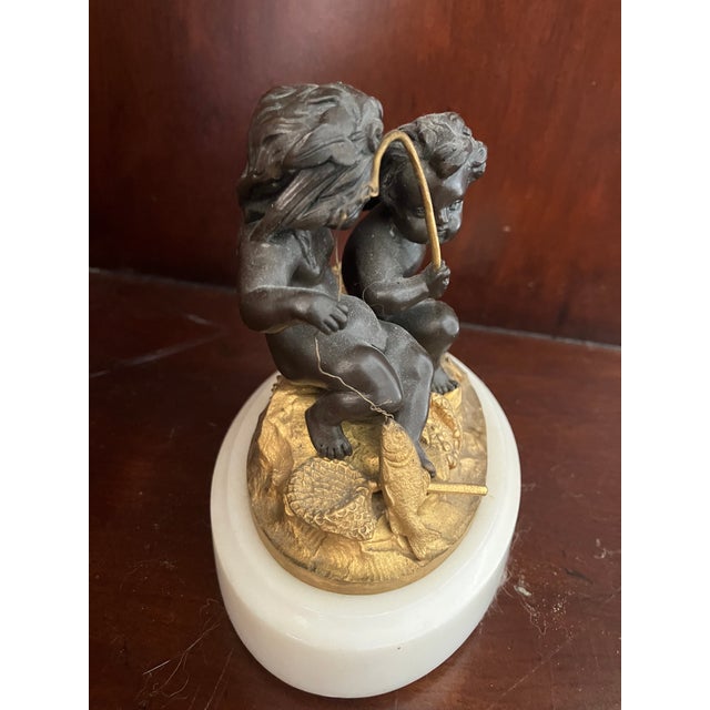 Fabulous 19th century French patinated and gilt bronze figural group. The bronze depicts two cherubs or Putti who are...