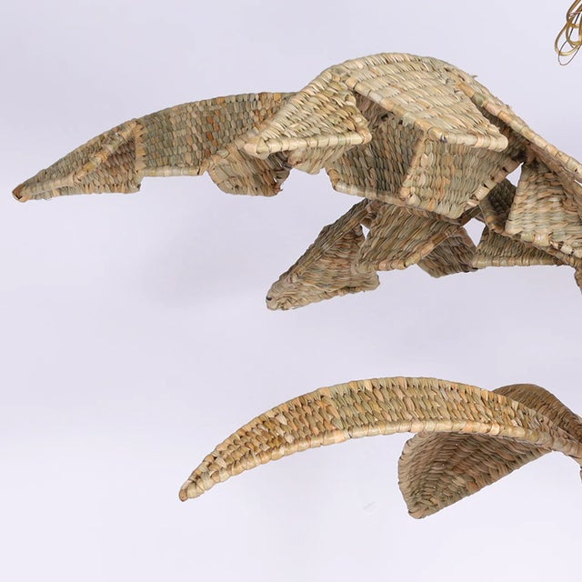 The Lola, a chic wicker six light chandelier crafted with a metal frame wrapped in reed in the highest quality with a bold...