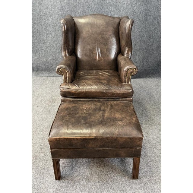 This Ethan Allen Leather Chippendale Wingback Chair with Ottoman features a timeless design with a rich brown leather...