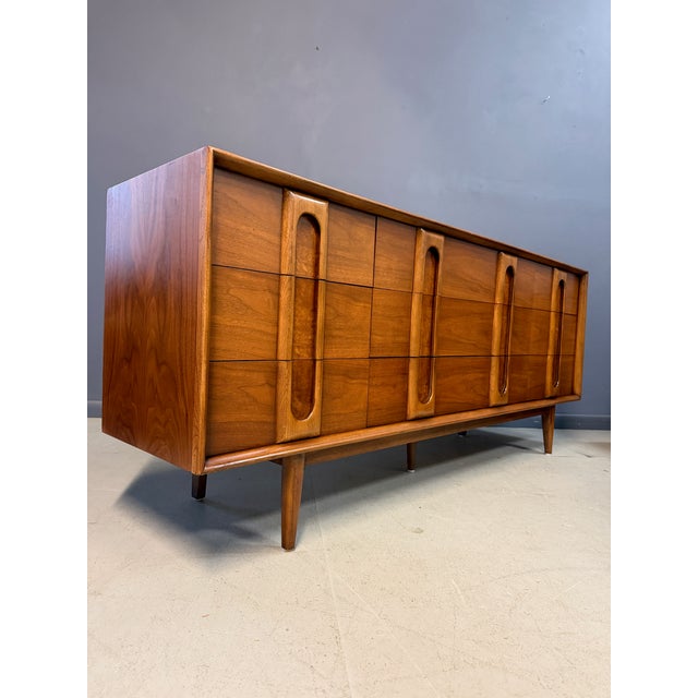 A striking vintage Lane Summit nine-drawer lowboy dresser, a standout of American mid-century modern design. Rich walnut...