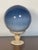 Art Glass blown crackled globe in shades of blue , 8”, on an onyx stone stand.