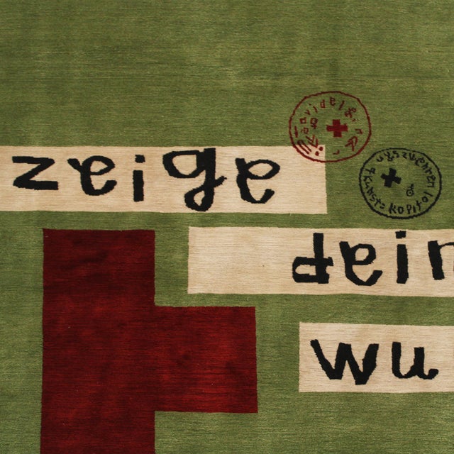This Spanish rug was designed by David Delfín. Its olive-green field is punctuated by a deep red cross-like form and the...