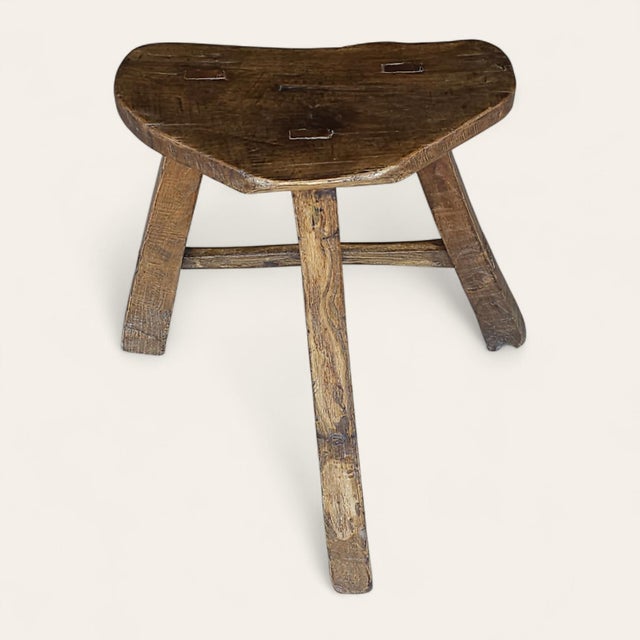 An early English joint stool, believed to date from the 17th–18th century, crafted in elm with a thick, organically shaped...