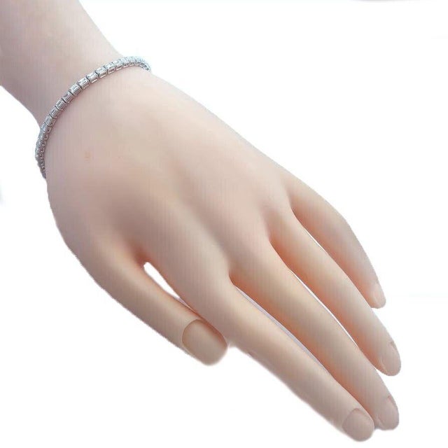 This is an eye-catching NEW line tennis bracelet. It is crafted from 18k white gold with a polished finish featuring the...