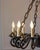 A striking 20th-century French chandelier crafted in wrought iron, distinguished by its sculptural presence and refined...