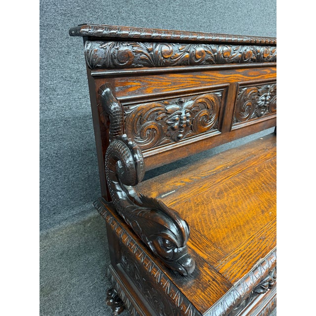 American quarter sawn oak hall bench in the manner of R.J. Horner, dating to the early 20th century. The bench features a...