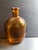 Mid-20th-century amber-colored glass whiskey bottle, featuring the countenance of George Washington - "The Father of His...