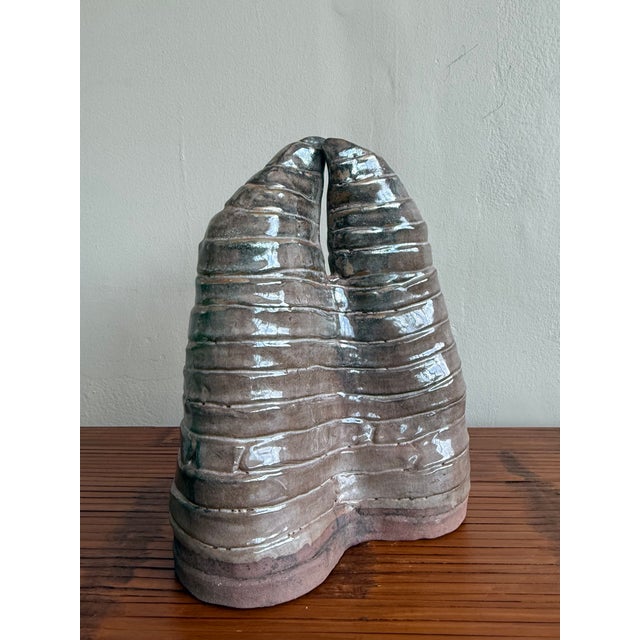 This one-of-a-kind boho ceramic sculpture brings an earthy, textural presence to any curated space. With its symmetrical,...