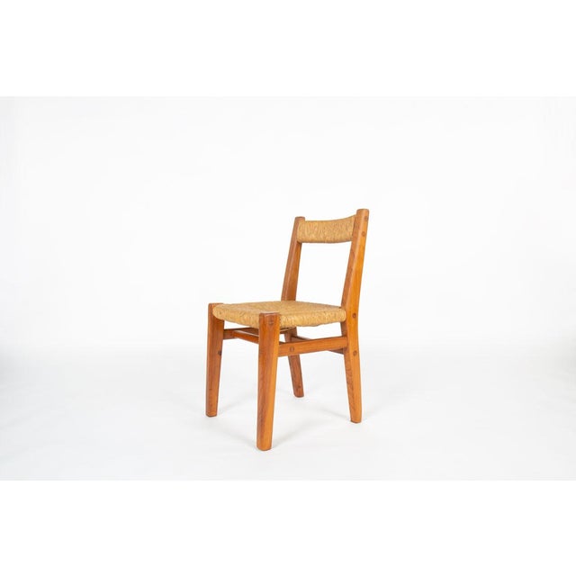 This set of six chairs was designed by French designer Charles Flandre during the 1950s–1960s. Crafted from solid elm and...