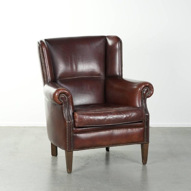 We are offering this charming vintage sheepskin armchair with a high back in a beautiful, understated design, finished...