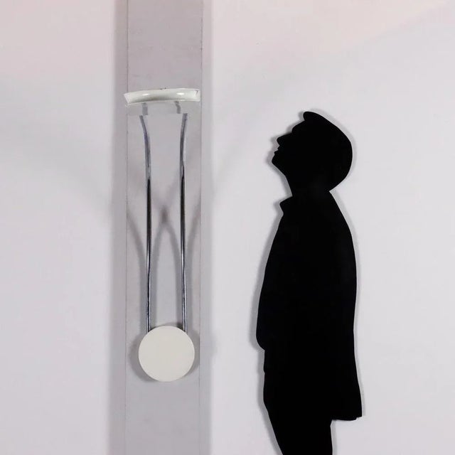 Reflected light wall lamp, in chromed metal and enamelled aluminium. This piece is attributed to the mentioned...