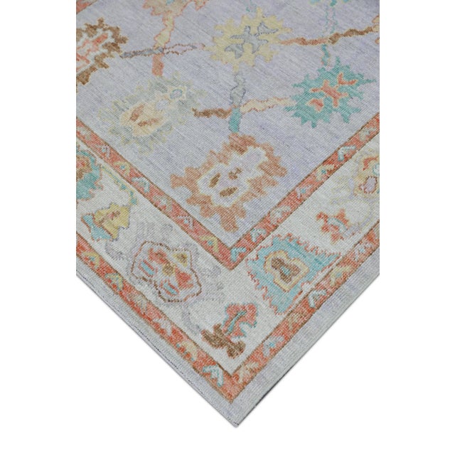 This modern Turkish Oushak rug is a stunning piece of art that has been handwoven using traditional techniques by skilled...