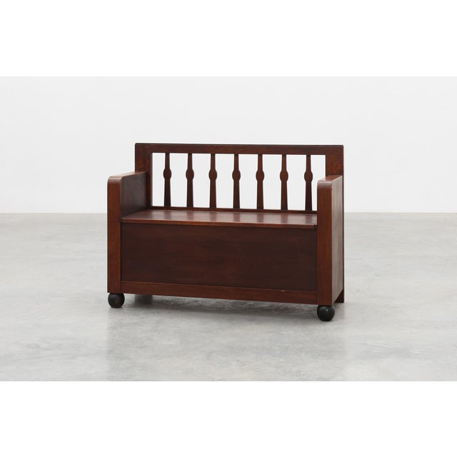 This Belgian Art Deco bench in solid oak exemplifies early modernist craftsmanship; a harmonious blend of geometric...